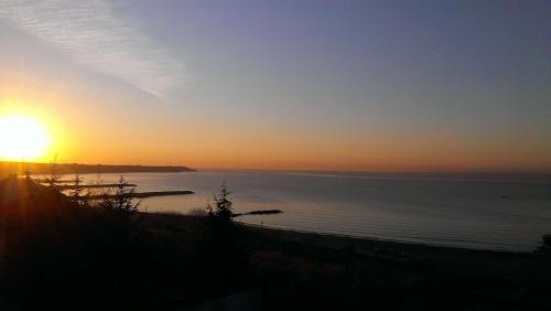 a sunset over a body of water at Family Hotel Lazuren Briag in Burgas City