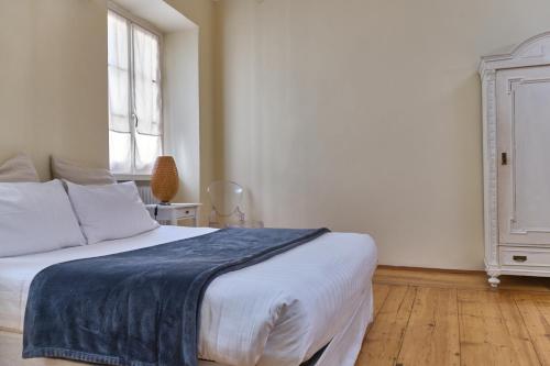 a bedroom with a bed with a blue blanket on it at Al Cavour 34 in Trento