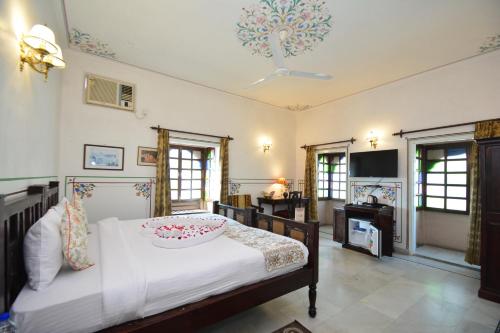 a bedroom with a bed with a bowl on it at Mahal Khandela - A Heritage Hotel and Spa in Jaipur
