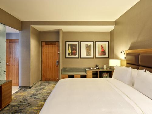 a hotel room with a large bed and a desk at Fiesta Americana Viaducto Aeropuerto in Mexico City