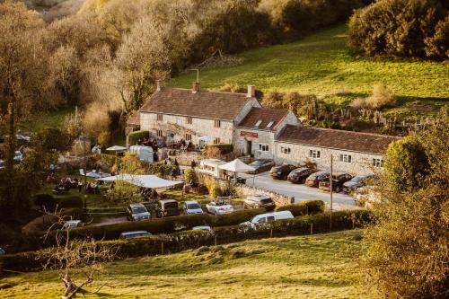 an aerial view of a village with cars parked in a parking lot at The Cotley Inn in Wambrook