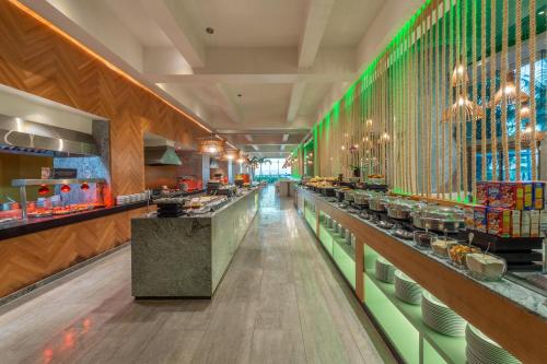 a restaurant with a long aisle with dishes on the counters at Live Aqua Cancun - Adults Only - All-Inclusive in Cancún