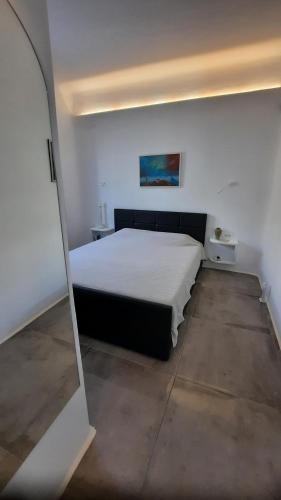 a bedroom with a large bed in a room at Arion suites Mykonos in Mýkonos City