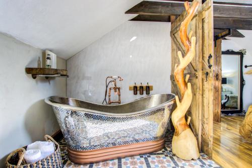 a bathroom with a large tub in a room at Unique Cottage The Old Stables Pembrokeshire Sleeps 8 - Welsh Tourist Board Award 5 Stars in Pembroke