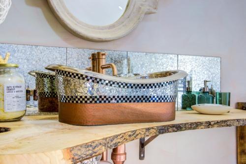 a bathroom counter with a copper sink on a counter top at Unique Cottage The Old Stables Pembrokeshire Sleeps 8 - Welsh Tourist Board Award 5 Stars in Pembroke