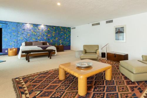 a living room with a couch a table and a bed at Camino Real Polanco Mexico in Mexico City