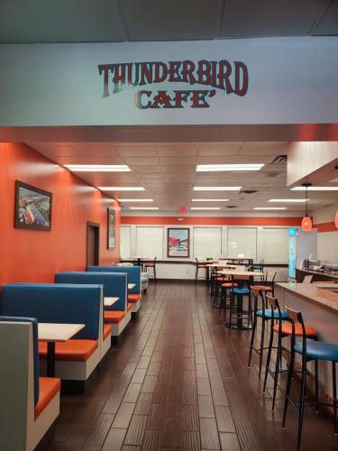 a dining room with tables and chairs in a restaurant at Howard Johnson by Wyndham Ocala FL I-75 in Ocala