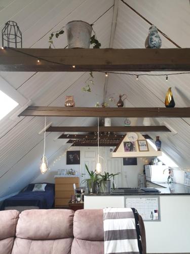 a living room with a couch in a attic at D'Lyon Stud and Sporthorses in Asarum