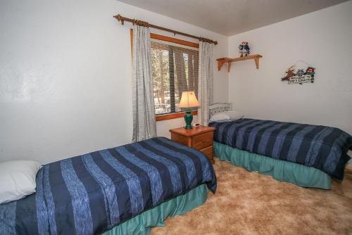 a bedroom with two beds and a window at R & R Retreat - 1767 by Big Bear Vacations in Sugarloaf