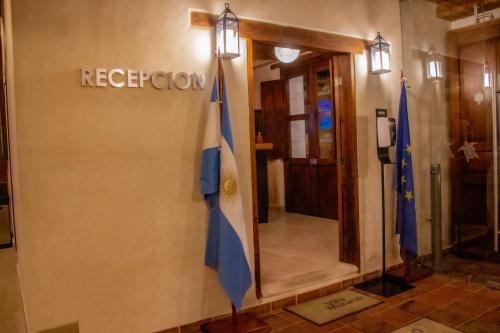 a lobby with two flags on the side of a building at Hotel Villa Murano in San Cristóbal de Las Casas