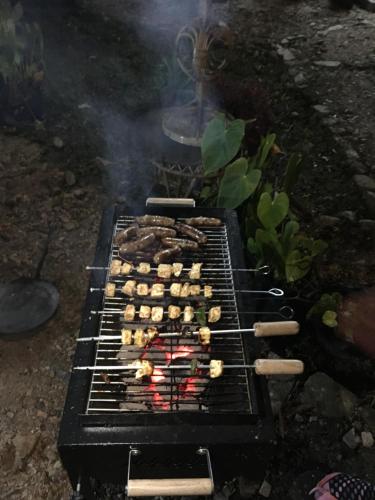 a grill with a bunch of food on it at Quo Vadis Farm in Māngwa