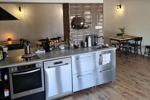a kitchen with white appliances and a table with chairs at Mihelyünk in Fonyód