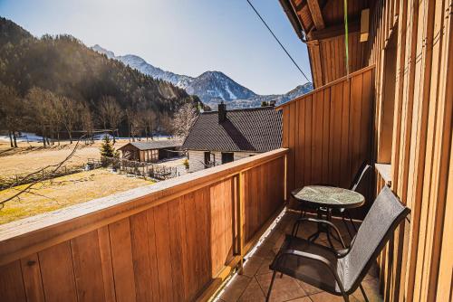 a balcony with a table and a chair on it at Homestay Kocka in Zgornje Jezersko