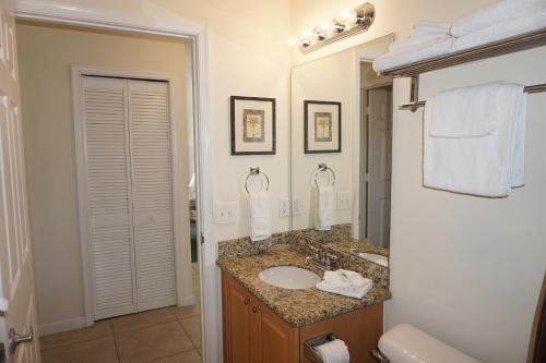 a bathroom with a sink and a mirror at Boca Ciega Resort by Travel Resort Services in St Petersburg