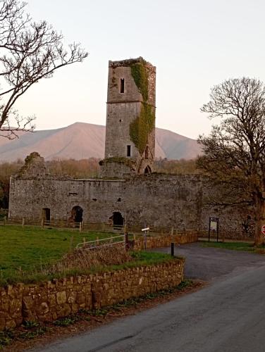 an old stone building on the side of a road at Corderry Farmhouse, idyllic cottage amid 250 acres in Stagdale Bridge