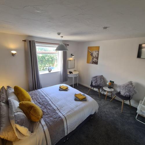 a bedroom with a bed and a window at The Coach House in Kegworth