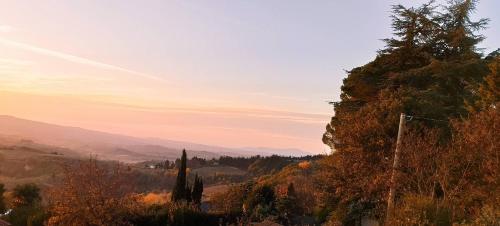 a view of a valley with trees and mountains at Poggio dei Carli in Marcialla