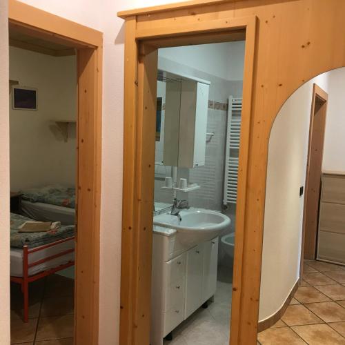 a bathroom with a sink and a mirror at Hotel La Tea in Livigno