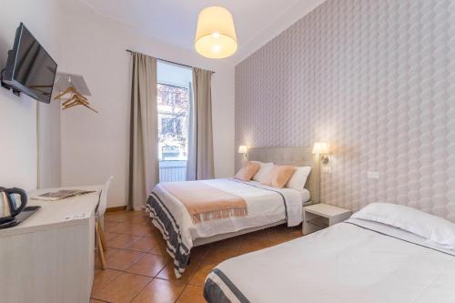 a hotel room with two beds and a television at I Mulini A Vento in Rome