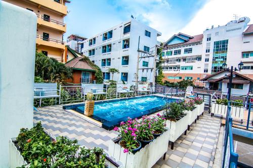 an apartment with a swimming pool and some buildings at Sutus Court 2 in Pattaya Central