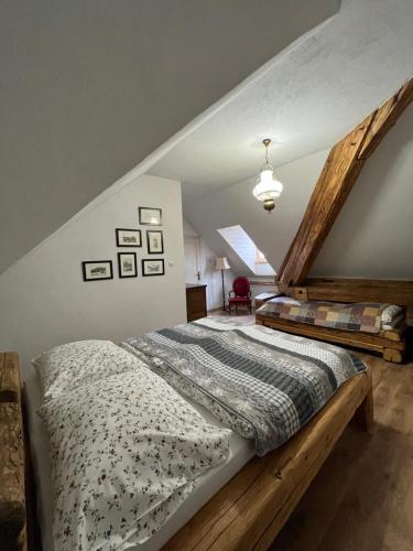 a bedroom with two beds in a attic at Apartmany pod schodami in Banská Štiavnica