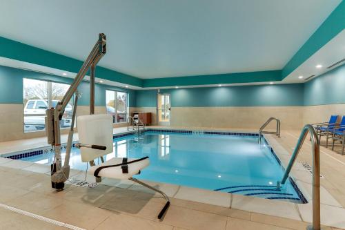 a pool in a hotel room with a swimming pool at Holiday Inn Express & Suites - Middletown - Goshen by IHG in Middletown