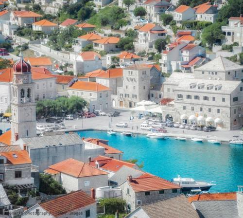 an aerial view of a town with boats in the water at Kaya house in Nerežišća
