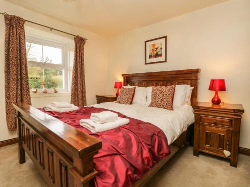 a bedroom with a large bed and a window at 14 Low Row in Holker