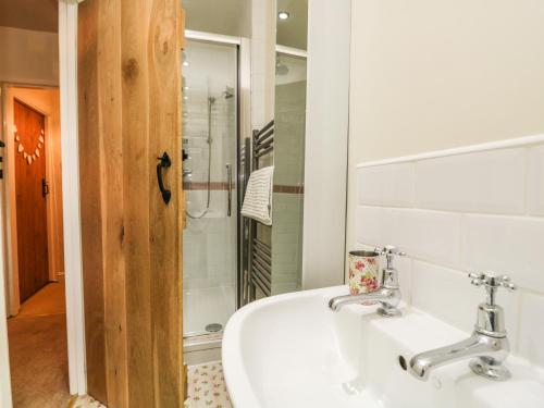 a bathroom with a sink and a shower at 14 Low Row in Holker