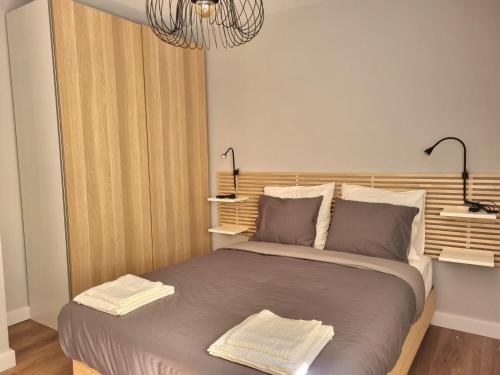 a bedroom with a bed with two towels on it at Aujada playa in Cádiz