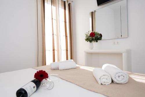 a kitchen counter with a bottle of wine and towels at Myconian Little Venice Elite Suites with Sea View in Mýkonos City