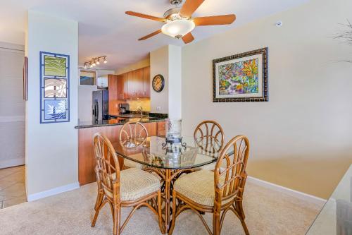 a dining room with a table and chairs and a ceiling fan at Mahana at Kaanapali in Kaanapali