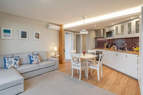 a living room with a couch and a table at The Boats Apartment by An Island Apart in Funchal