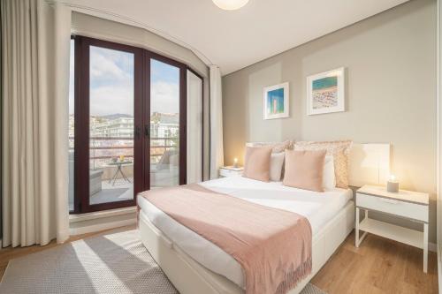 a bedroom with a bed and a large window at The Boats Apartment by An Island Apart in Funchal