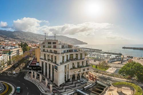 a view of a city with a building and the ocean at The Boats Apartment by An Island Apart in Funchal