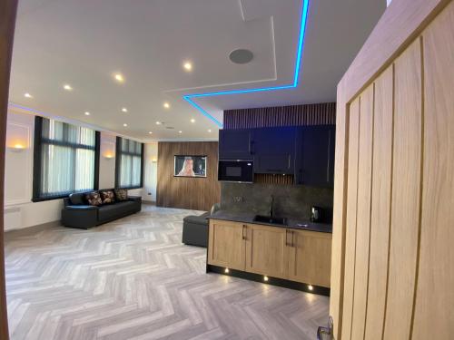 a large living room with blue lights on the ceiling at Eleanor Rigby apts Stanley Street in Liverpool