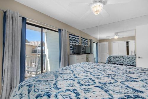 a bedroom with a bed and a balcony at Southwind I-9 in Panama City Beach