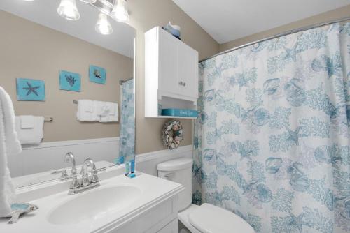 a bathroom with a toilet and a shower curtain at Southwind I-9 in Panama City Beach