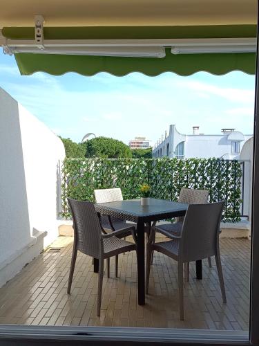 d'une table et de chaises sur une terrasse avec balcon. dans l'établissement SPARKLE-STUDIO PROCHE PLAGE PLEIN CENTRE PARKING WIFI TERRASSE - La Grande Motte, à La Grande Motte