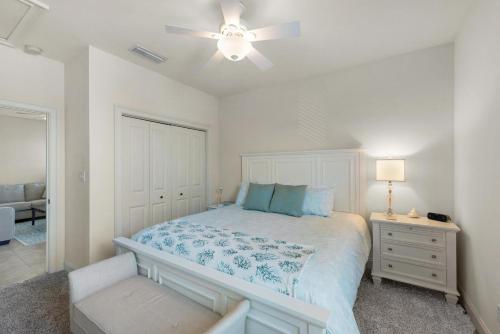 a bedroom with a bed and a ceiling fan at Topsail Village 422 in Santa Rosa Beach