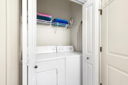 a white laundry room with a washer and dryer at Topsail Village 422 in Santa Rosa Beach