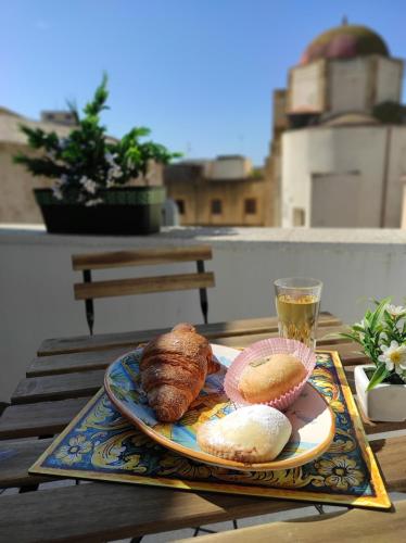 a plate of bread and a drink on a table at Da Marilù in Mazara del Vallo
