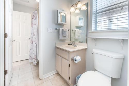 a bathroom with a toilet and a sink and a mirror at Beachside Villas 332 in Santa Rosa Beach