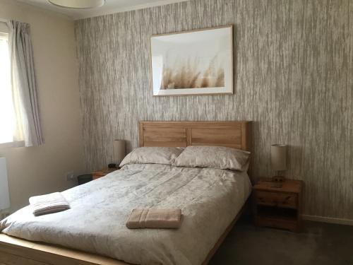 a bedroom with a bed and a picture on the wall at "An Comaraich - The Sanctuary" in Inverinate