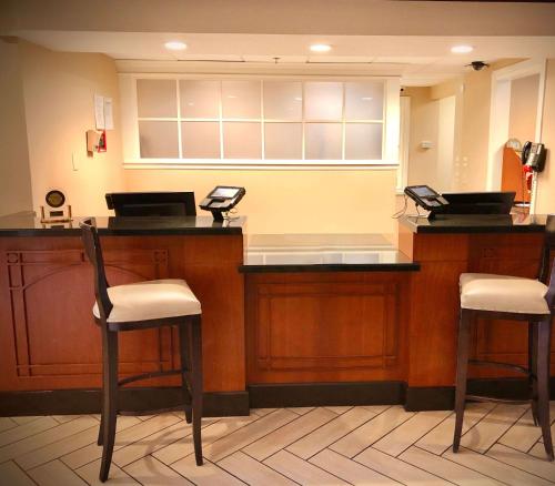 a waiting room with two stools and a cash register at Sonesta ES Suites San Francisco Airport San Bruno in San Bruno