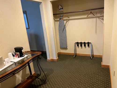 a bathroom with a shower with a tie in it at Days Inn & Suites by Wyndham Sutton Flatwoods in Sutton