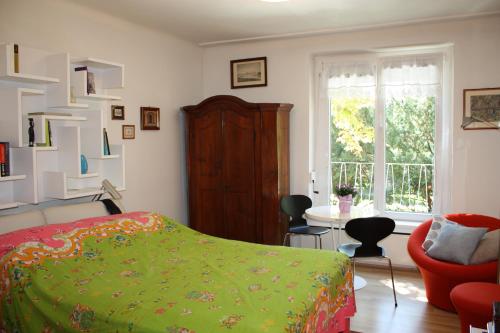 a bedroom with a bed and a chair and a table at GoVienna - Charming Studio in Vienna
