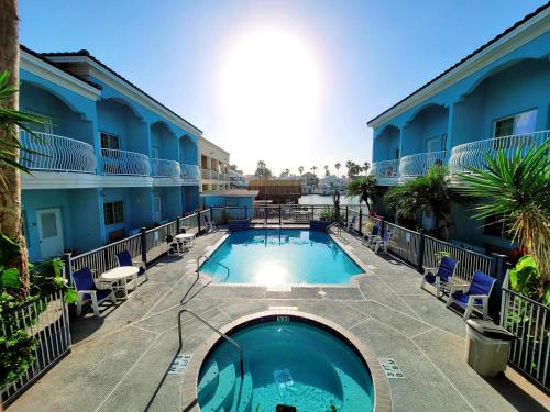 a swimming pool in the courtyard of a hotel at Casa Bella Hotel and Suites in South Padre Island
