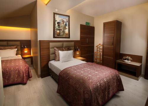 Tempat tidur dalam kamar di Elit Asya Hotel