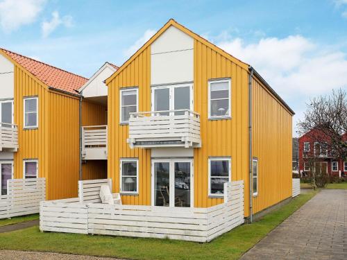 a house with an orange and white exterior at 4 person holiday home in Rudkøbing-By Traum in Rudkøbing
